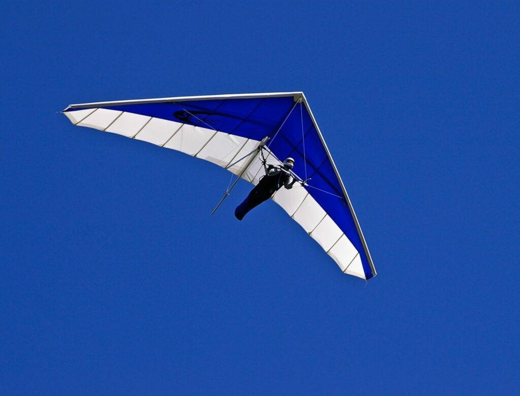 Person stepping out of his comfort zone & hang gliding